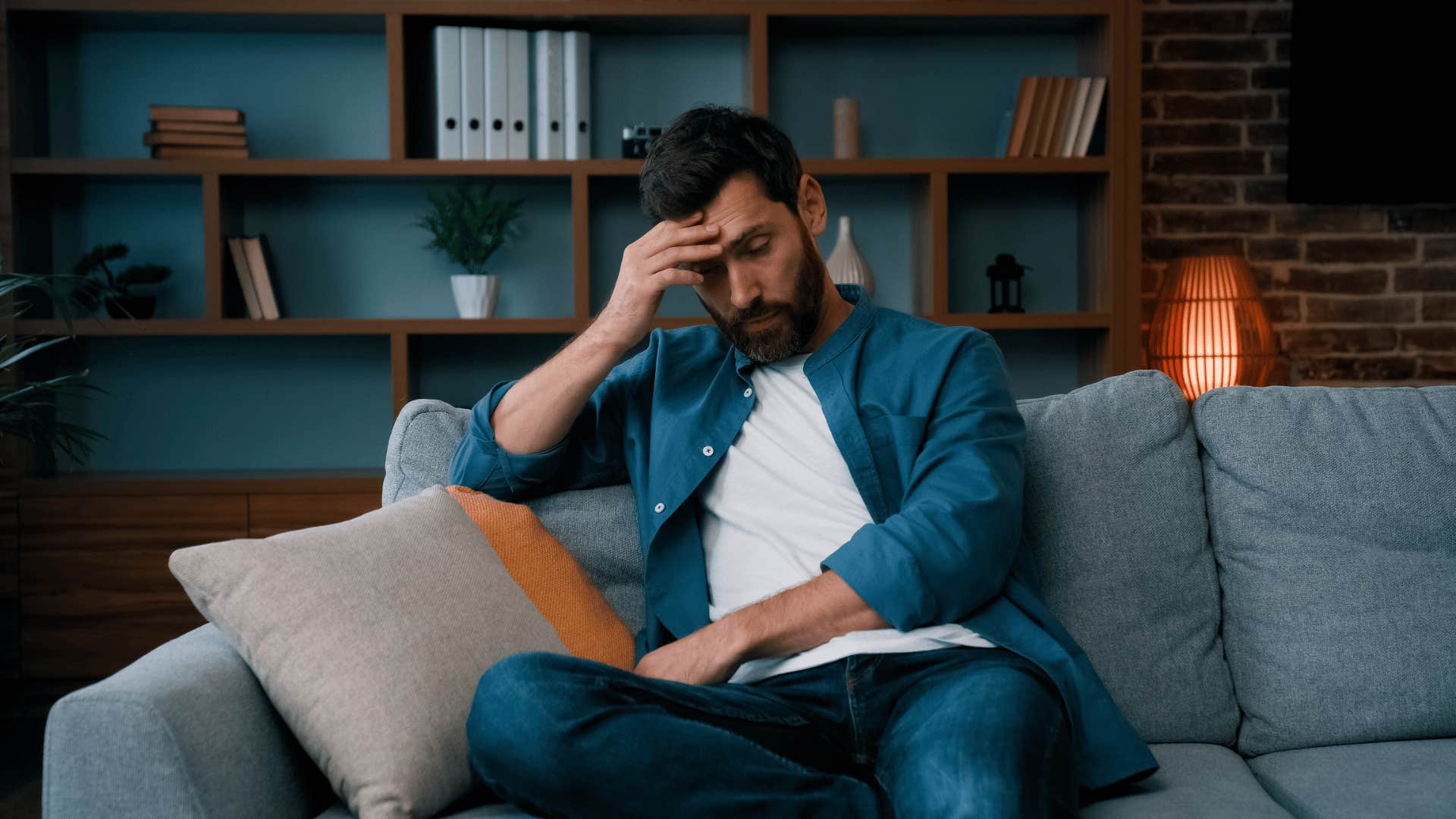 upset man sitting on couch