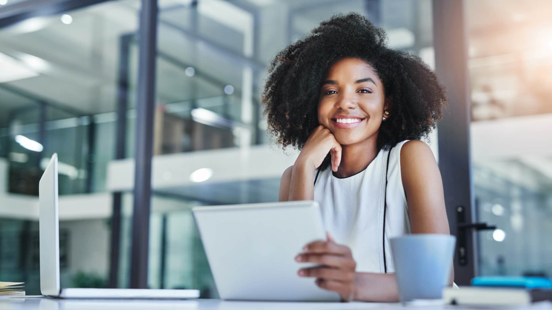 young gen z woman sitting in office redefining work culture