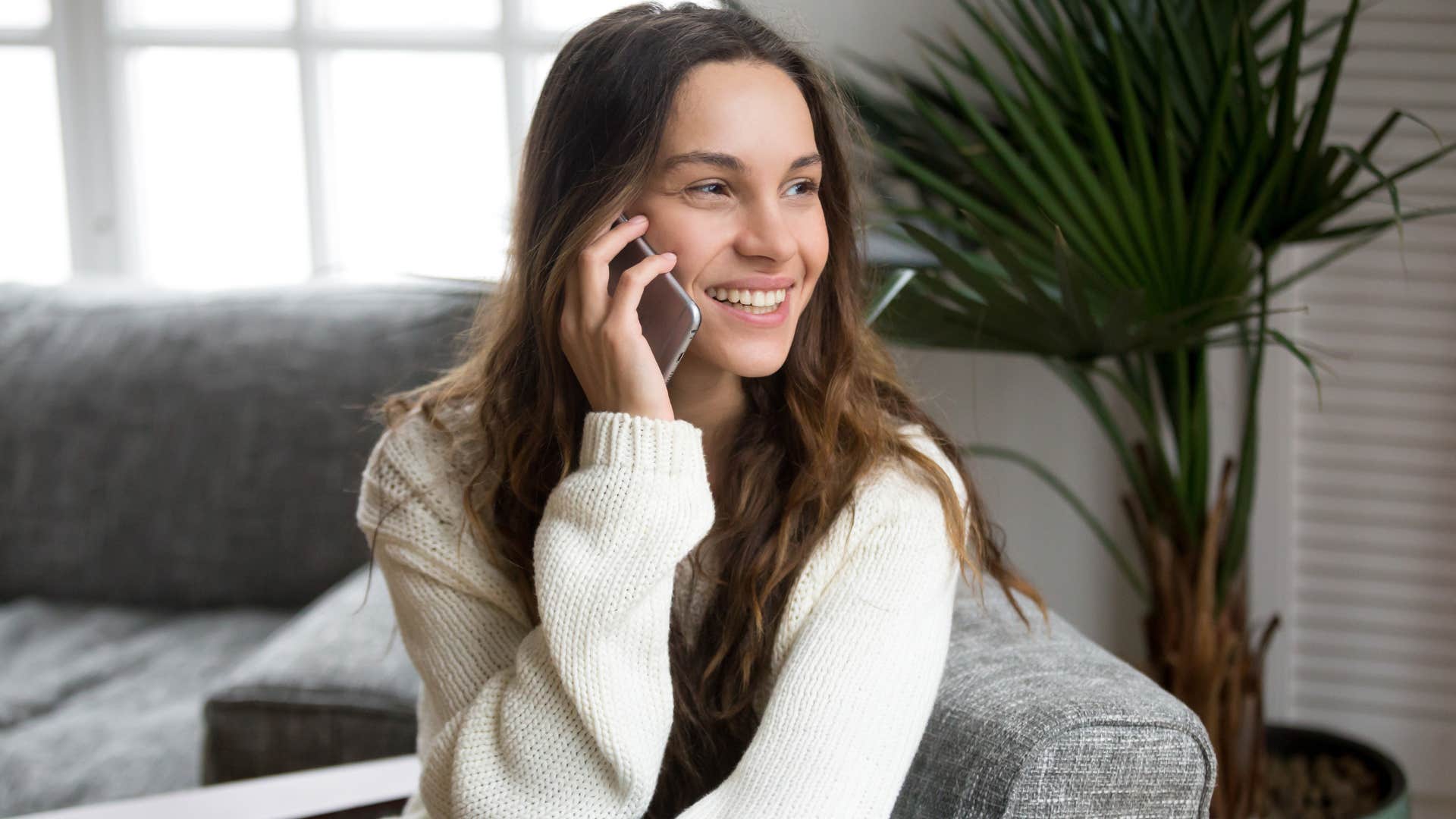 woman politely ending a phone call by saying thank you