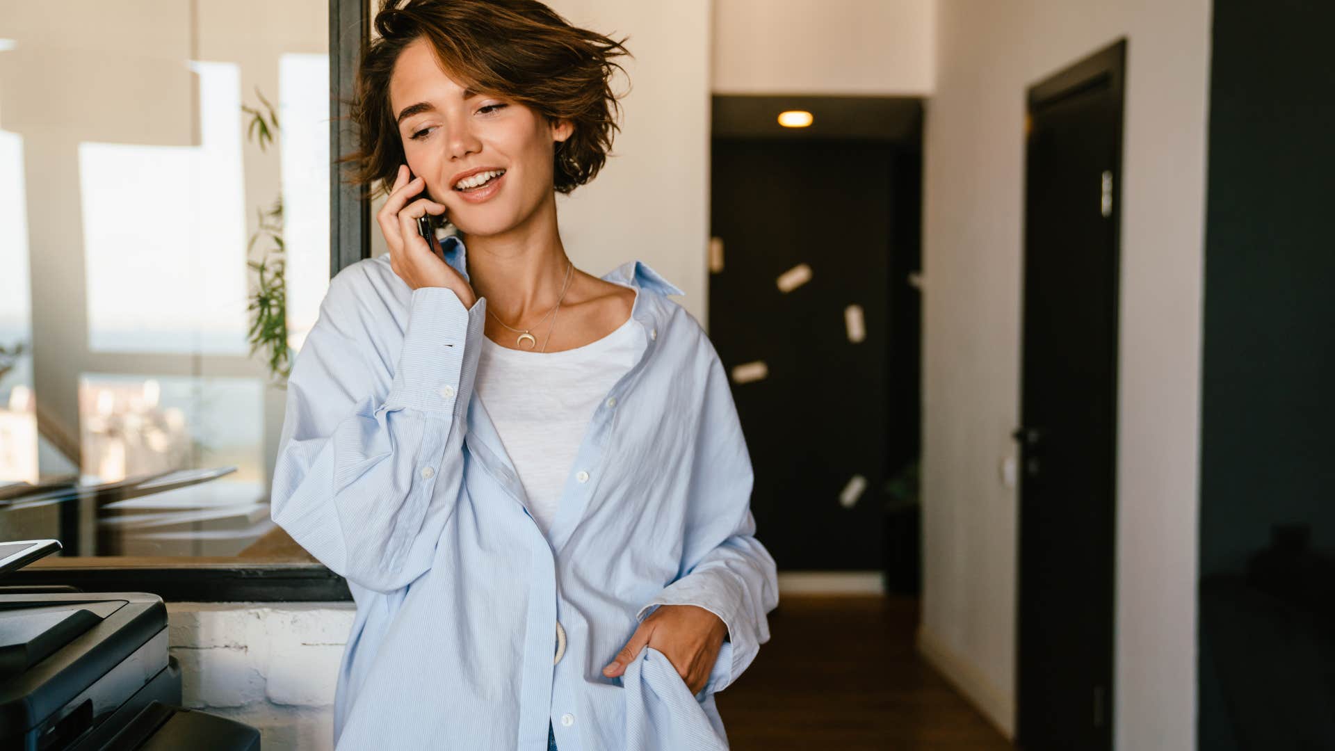 woman politely ending a phone call by saying I wish I could talk longer