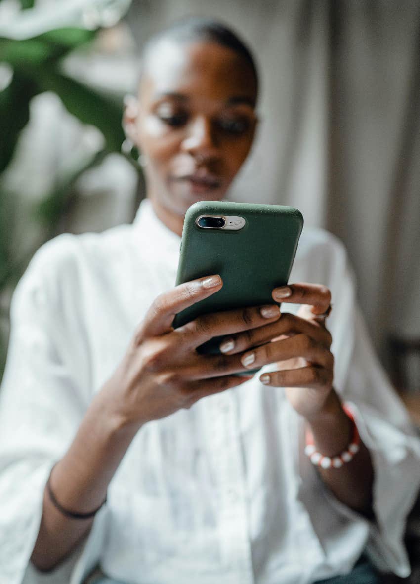 woman using social media on her phone