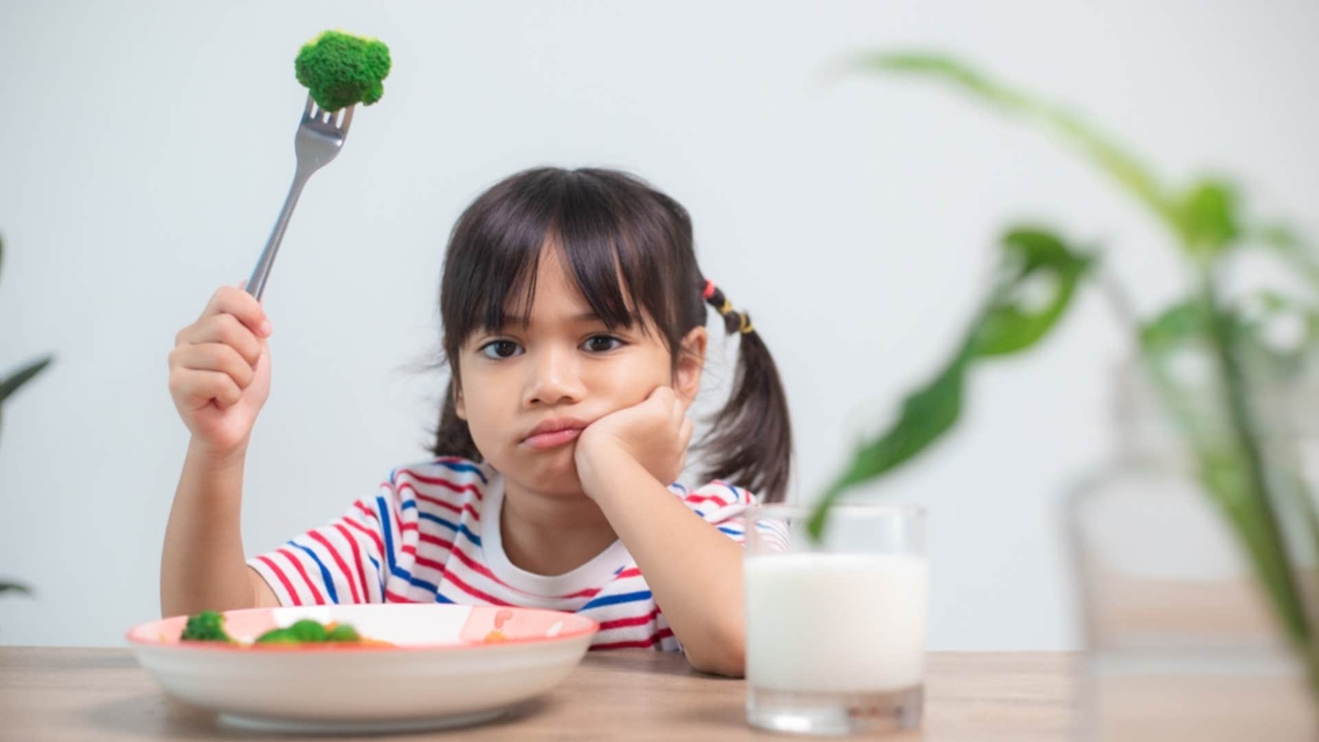 little girl being expected to finish everything on their plate plate 