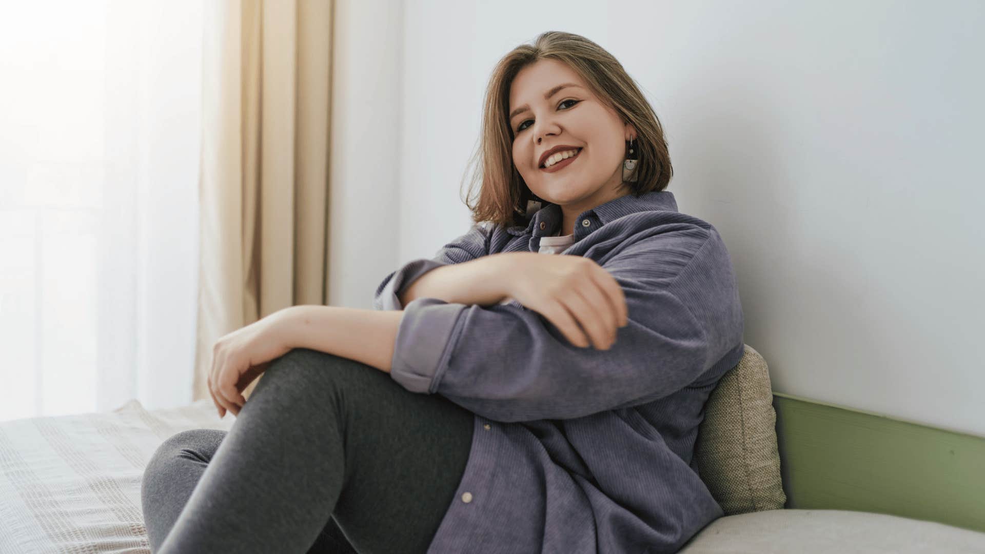 woman sitting on bed trusting herself