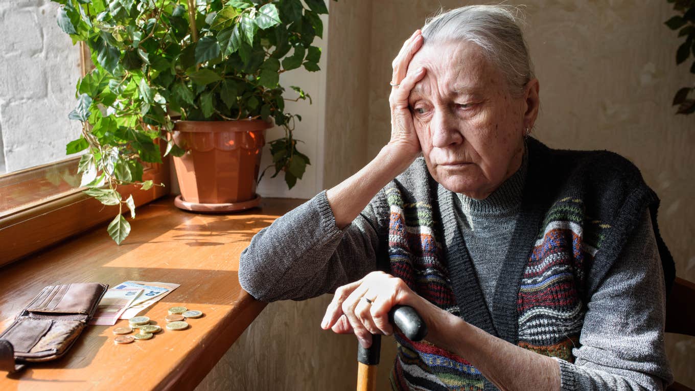 Unfortunate Things People Have In Their Homes That Keep Them Broke, According To Feng Shui broke and upset woman looking at money in her home