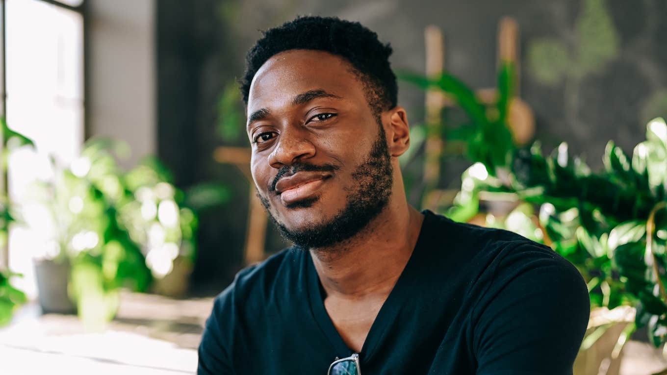 Brilliant Ways Introverts Make The Most Of Their Alone Time smiling introverted man enjoying alone time at home