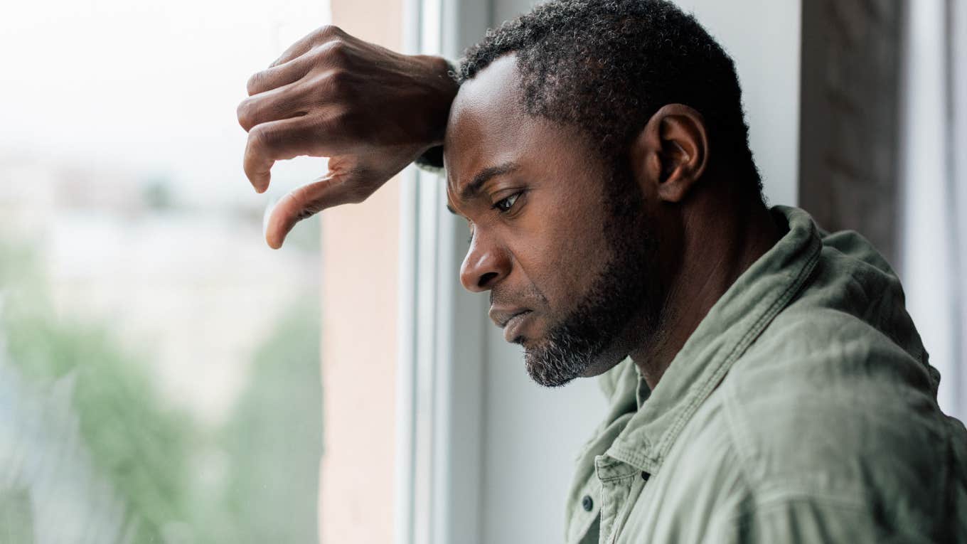 Dad Financially Cuts Off His Stepdaughter After He Didn't Receive An Invitation To Her Graduation upset man looking out of window