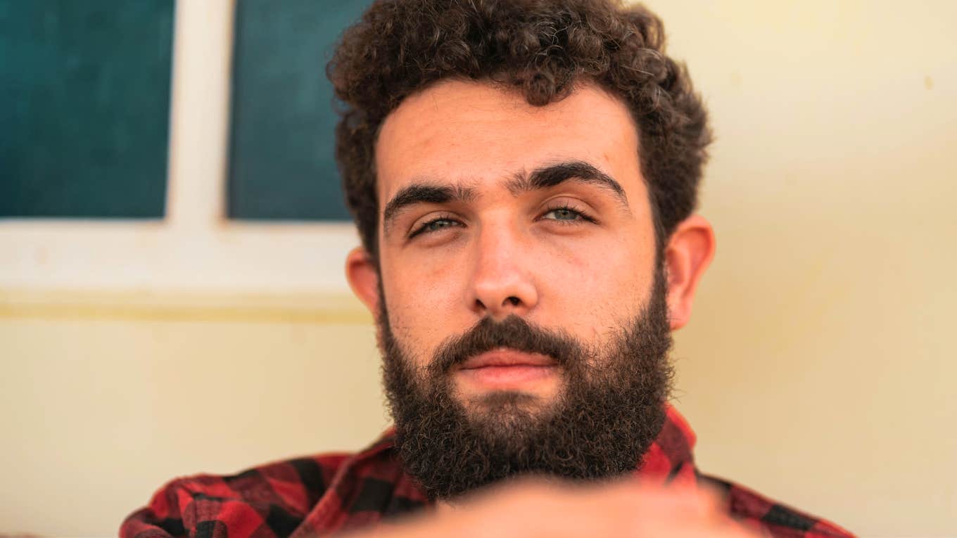 Hurtful Things Men Do When They’re Terrified of Catching Feelings, According To Therapist Man doing hurtful things because he is terrified of catching feelings.