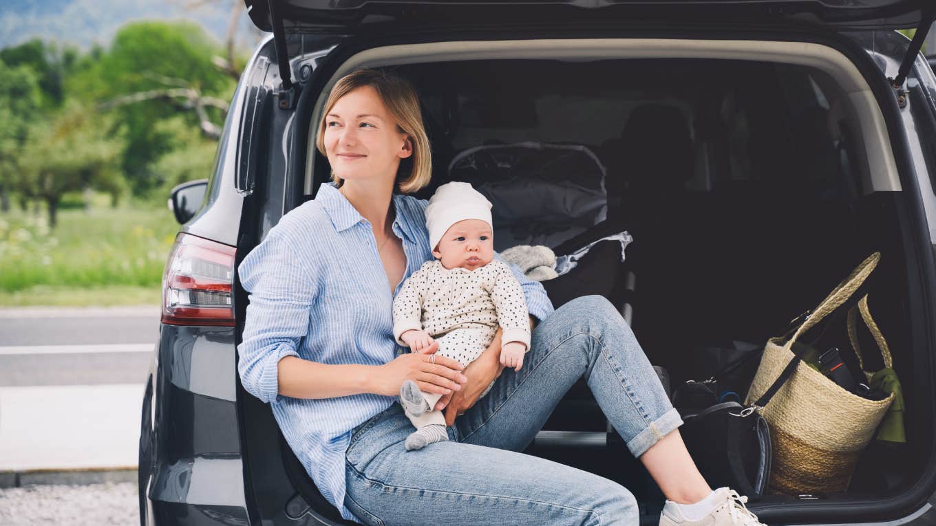 Mom Leaves 2-Year-Old Son At Home To Go On Vacation With Her Husband And Their Newborn mom holding newborn while sitting in back of car