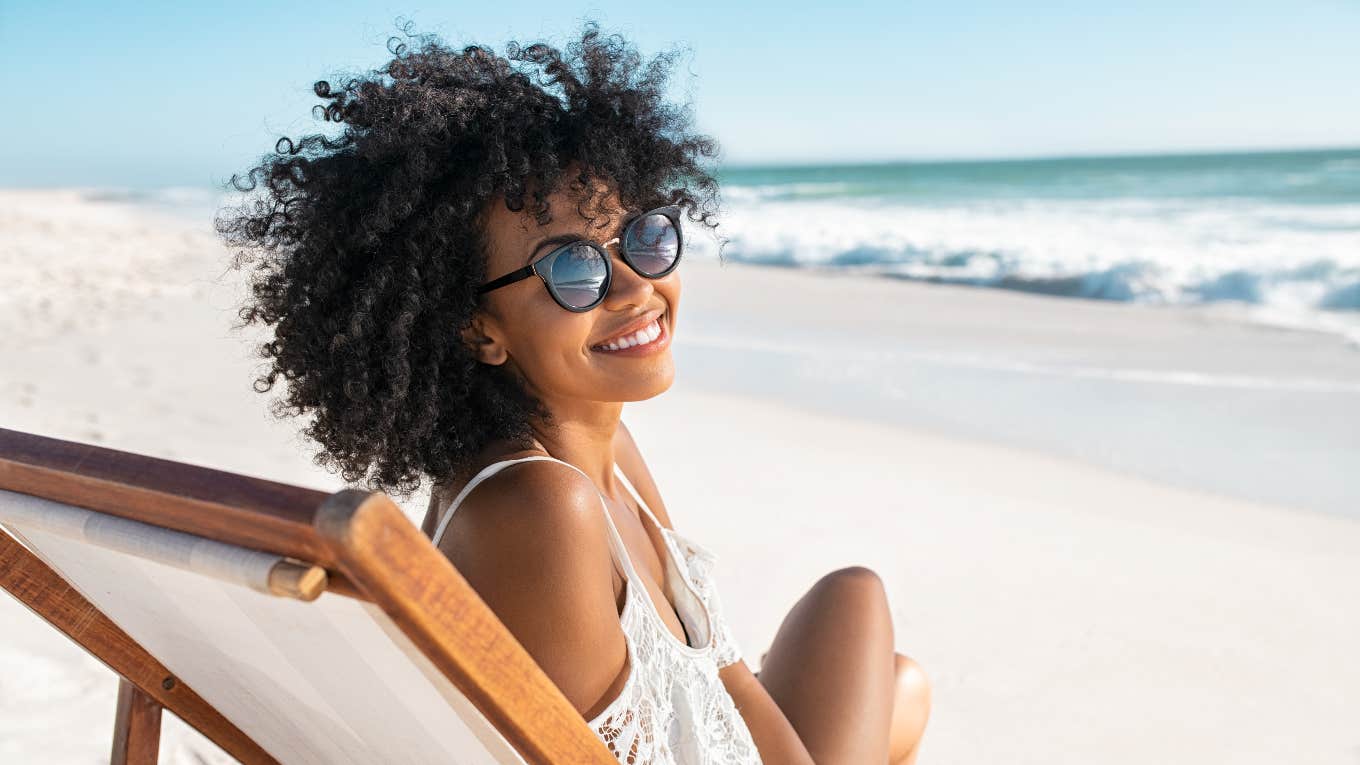 survey shows requirements for perfect vacation woman sitting on beach enjoying perfect vacation