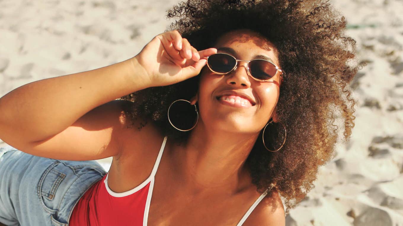 Travel More, Live Longer? Science Says These Benefits Might Add Years To Your Life Woman on vacation, traveling more to live longer.