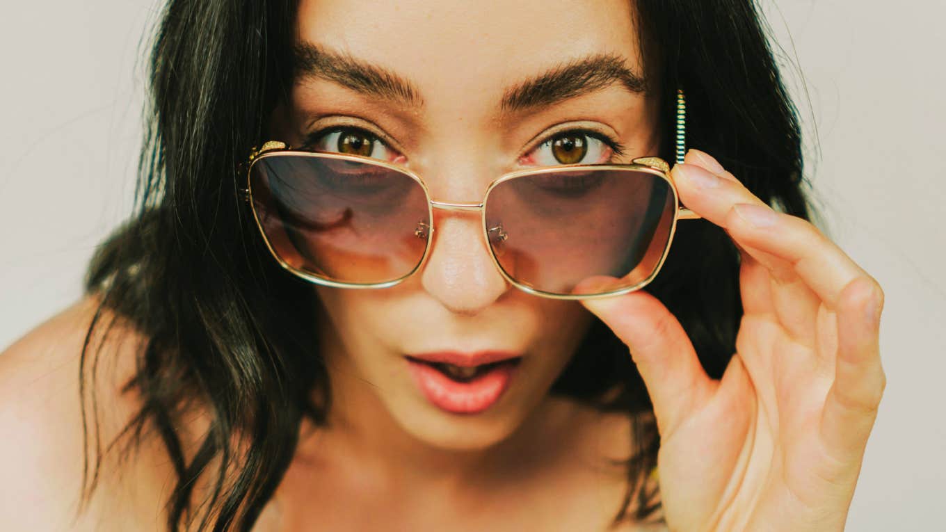 Mindset Shifts That Instantly Make You a Better, More Compassionate Human, According To Psychology Curious woman making a mindset shift that make her a more compassionate human.