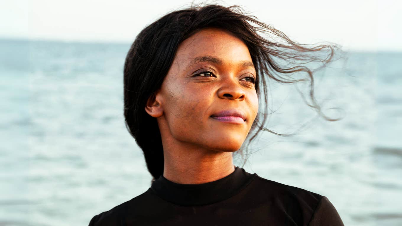 TK Powerful Steps To Transform Your Life Without Ditching Your Job, According To Research Woman transforming her life without ditching her job.