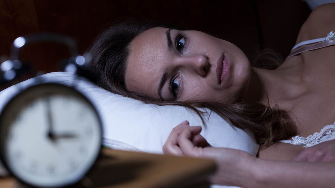 Reasons Secretly Brilliant People Usually Struggle To Fall Asleep brilliant woman struggling to fall asleep looking at the clock