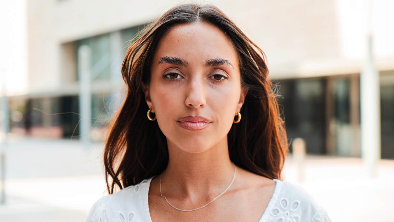 Things That Instantly Make Someone Look Low Class, According To Psychology serious looking woman seeming low class
