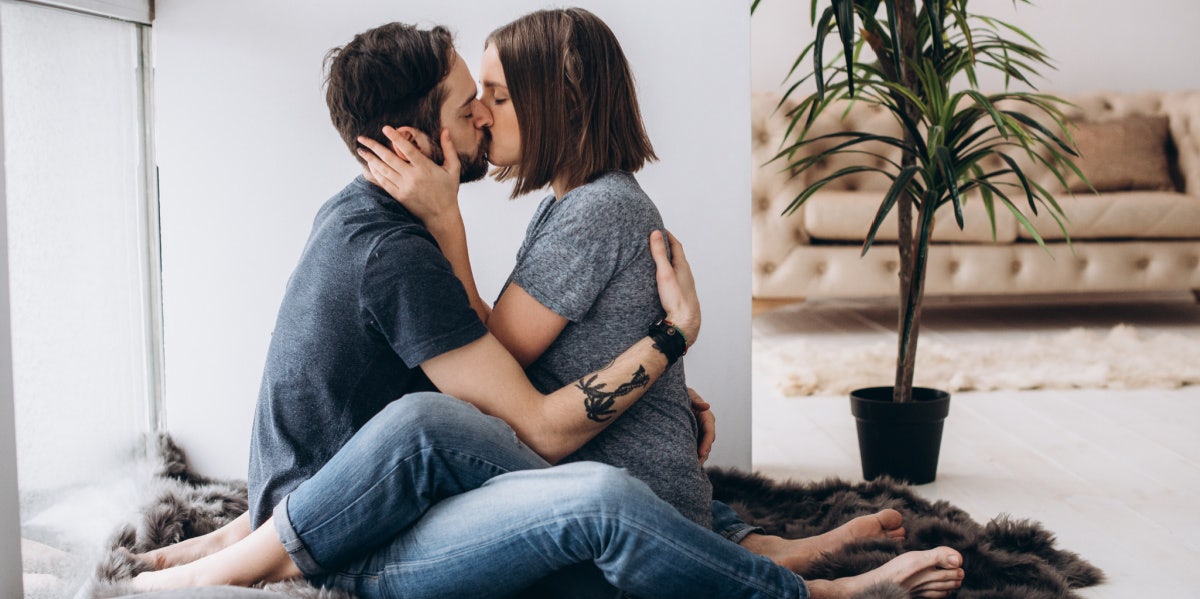 Romantic couple embracing in studio shot, just about to kiss, man
