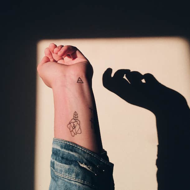 Minimalist air symbol tattoo on the inner arm