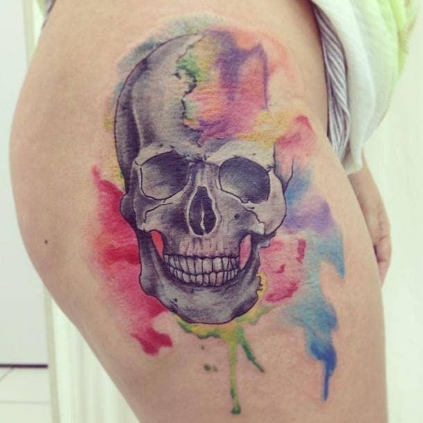 Watercolor skull tattoo done on the bicep