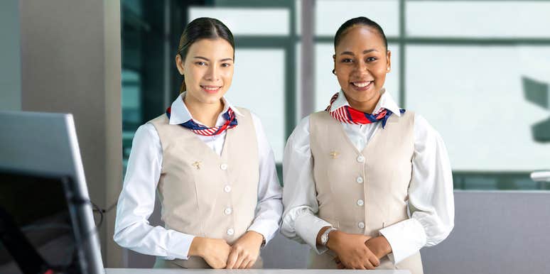 flight attendants posing with smile at the check in counter