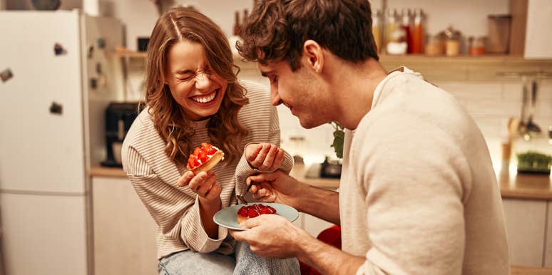 couple laughing while eating together