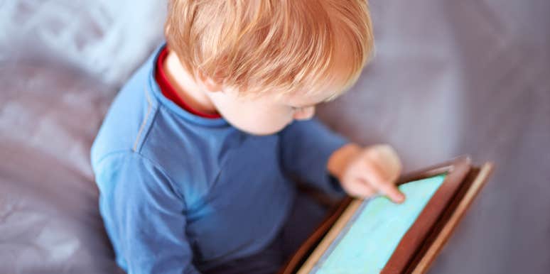 baby boy playing on tablet