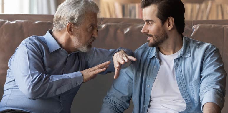 Boomer dad and husband having a conversation on couch. 