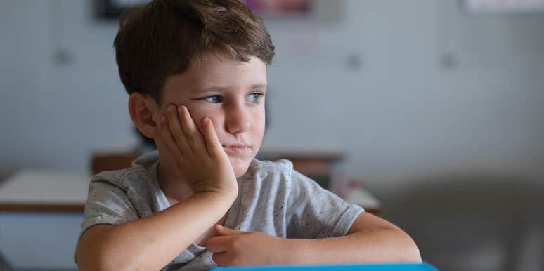 Sad young boy in school