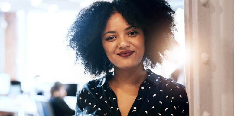 Confident woman smiling in the office.