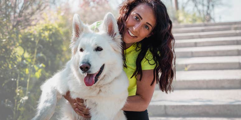 Dog owner smiling while bringing her dog in public. 