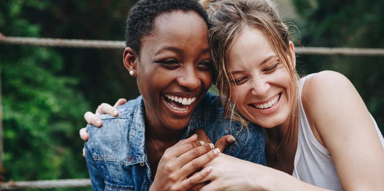 two friends hugging and smiling