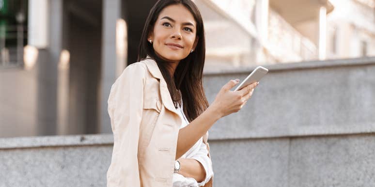 Woman being charming over text, holding phone