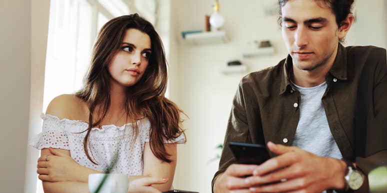 Woman feeling ignored by husband on his phone