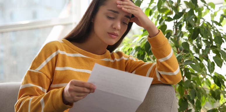 Depressed bartender reading the note from her boss