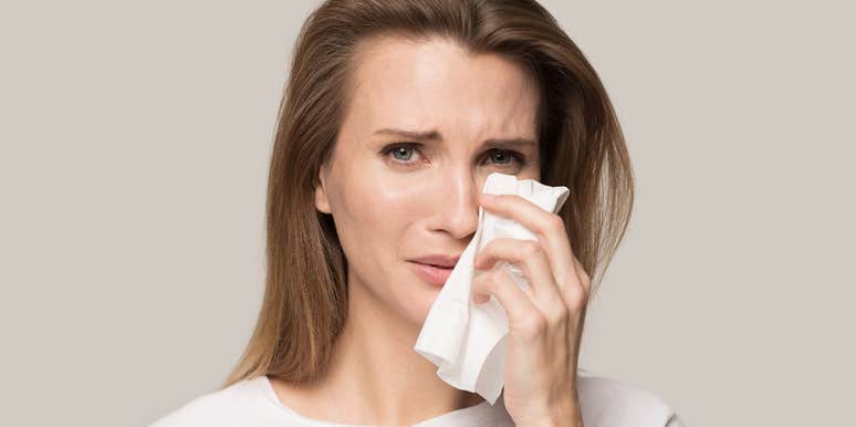 Grieving woman crying over her late dog