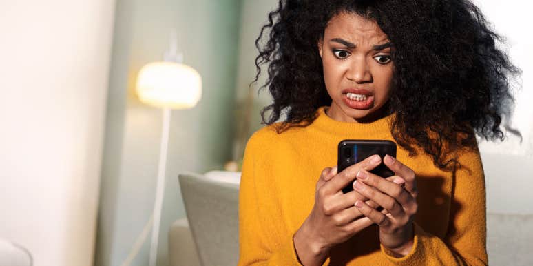 Woman looking at phone because ex is trying to get her back.