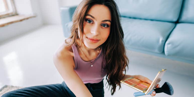 Woman spending time with herself, doing makeup.