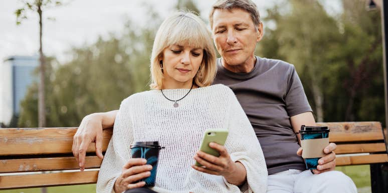 Husband and wife sitting on bench 