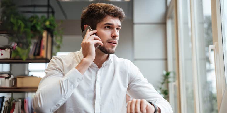 Man talking on phone and looking at watch