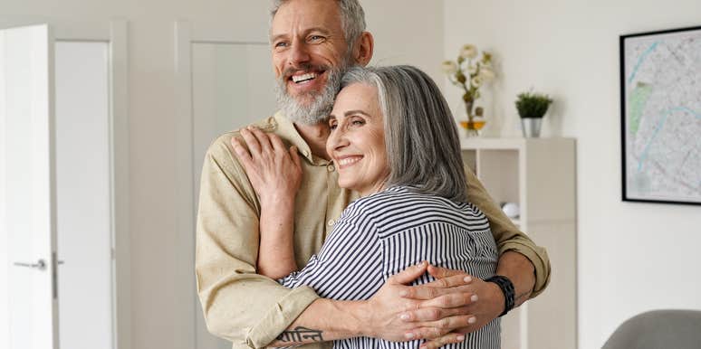 older couple hugging in a living room