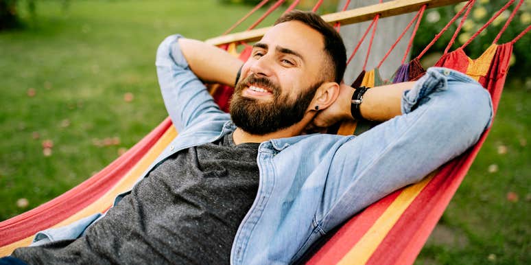 Man with high IQ, lounging in hammock. 