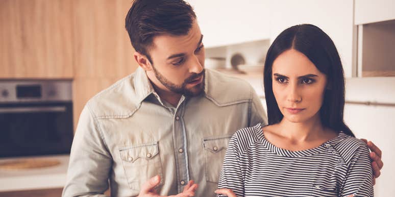 Couple breaking up in their kitchen over a messy silverware drawer