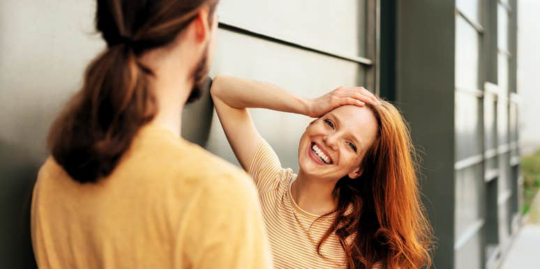 Woman using flirty body language to speak to man