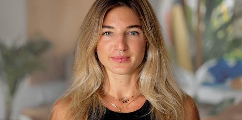 Adult woman smiling at the camera in her home.