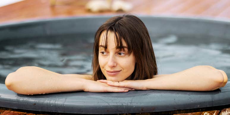 Female soaking in a hot tub to calm her racing mind.