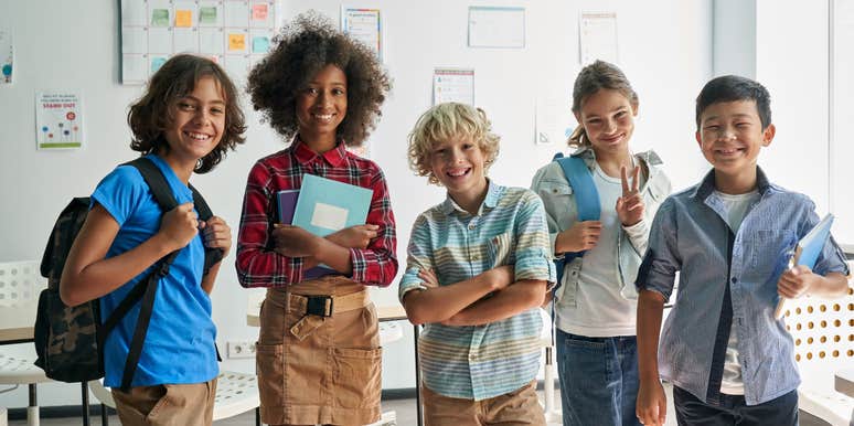 group of middle schoolers standing in front of a white board