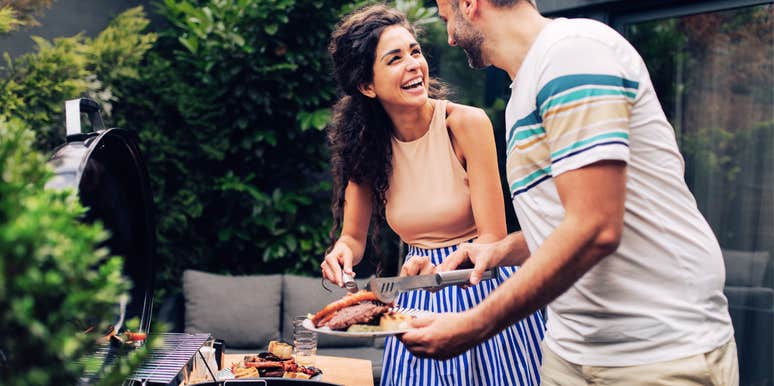 Woman being kind to her husband, making him lunch on the grill. 