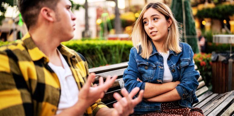 Woman looking suspiciously at man who is cheating. 