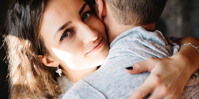 Wife encouraging her husband to be more emotionally vulnerable with a hug.