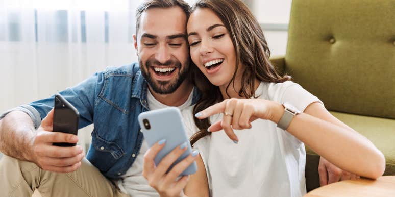 A woman and a man looking at memes on their phones