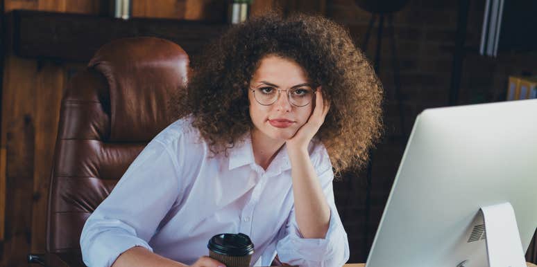 Employee sitting at desk with a cup of coffee