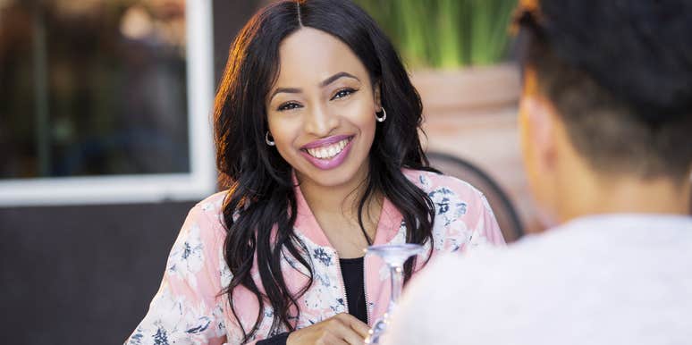 Woman smiling at her ex who is her friend at a table